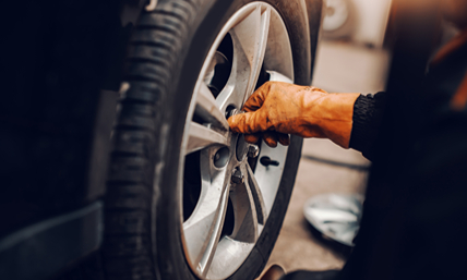close-up-auto-mechanic-changing-tire-workshop